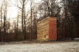 View from east, showing Douglas fir log walls on concrete plinth