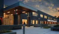 A large overhang welcomes students and guests to the facility. The composite wood soffit creates a warm inviting glow and is engineered to last for generations.