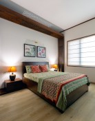 Nalukettu-inspired wooden frame around the bedside