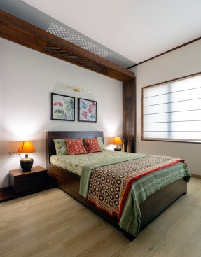 Nalukettu-inspired wooden frame around the bedside