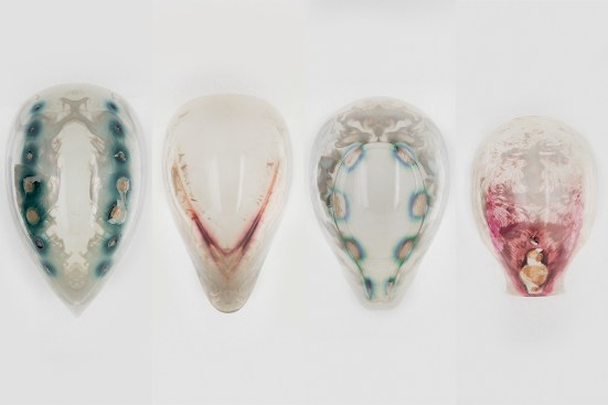 Chemical signals embedded in a series of masks 3D printed by the Media Lab's Mediated Matter group caused living engineered bacteria coated onto the masks to produce colors only in the areas treated with the chemical signals.