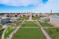 Tisch Park is the central green space in the East End plan. Round skylights embedded in the grass allow natural light to filter into the parking garage below, and the use of five different types of blended soils contribute to resilience, horticultural health, and moisture retention that delays the release of stormwater and filters water from the site. The landscape design also introduces a much greater diversity of plants than were previously on-site, and the new allée of trees will provide shade as they grow, while maintaining the focus on historic Brookings Hall.