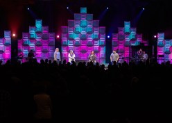 The stage design team at Blue Ridge Community Church created a versatile luminous wall using translucent ceiling panels that were illuminated from the rear. The top of each section was tapered to suggest the shape of cathedral arches. The wall, in the main sanctuary, was 18 feet tall at the center, yet very lightweight.