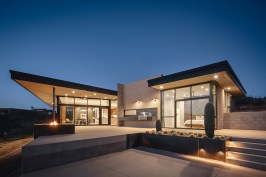 Terraced patio off the master suite and main living area.  Sand finish concrete patios, raw steel planters and floating BBQ create the main outdoor living area.