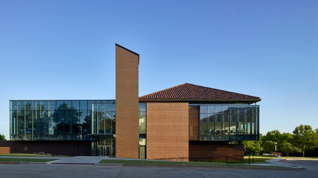 The north elevation illustrates the intersection of the dual facades as the traditional masonry and clay tile roof on the west begins to transition to zinc cladding and glass on the east.