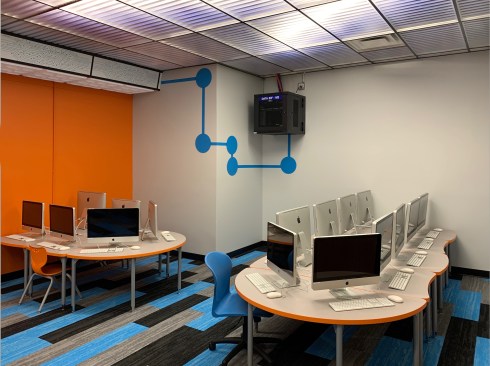 The computer lab for first and second graders at Morton Gingerwood Elementary School was transformed from an outdated room to a 21st Century learning space on a tight budget, by a creative application of paint, carpet, and translucent ceiling tiles. The luminous ceiling has economical LED strips above the frosted panels and diffuses light throughout the room with minimal glare.
