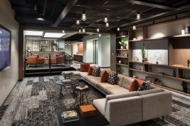 The lower lounge flows into a more casual seating area with a galley, fitness center, a work lounge, and conference center.
