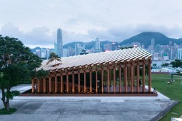 Growing Up, a pavilion in the West Kowloon Arts and Culture District in Hong Kong, uses timber columns to help frame views of the adjacent harbor.