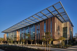 Building shaded by unique curtain and architectural awning at roof