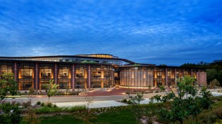 South façade at dusk featuring commissioned wind-interacting artwork