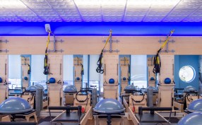 A chain of Club Pilates exercise studios in Southern California have created a signature décor built around a
Ceilume decorative thermoformed ceiling with a blue glow lighting up the edge.