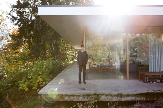 Andrew Philip Kwai-Hoon Heid, founder of No Architecture, in front of his Courtyard House project in Aurora, Ore.