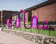 The arches mimic and challenge the architecture of the existing building.