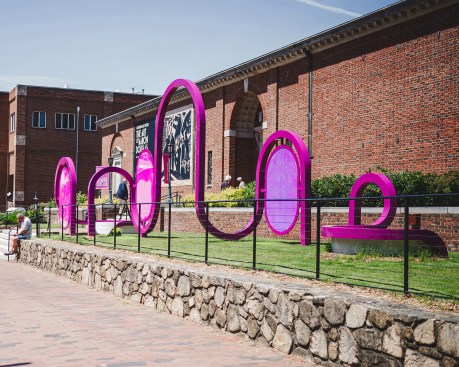 The arches mimic and challenge the architecture of the existing building. 