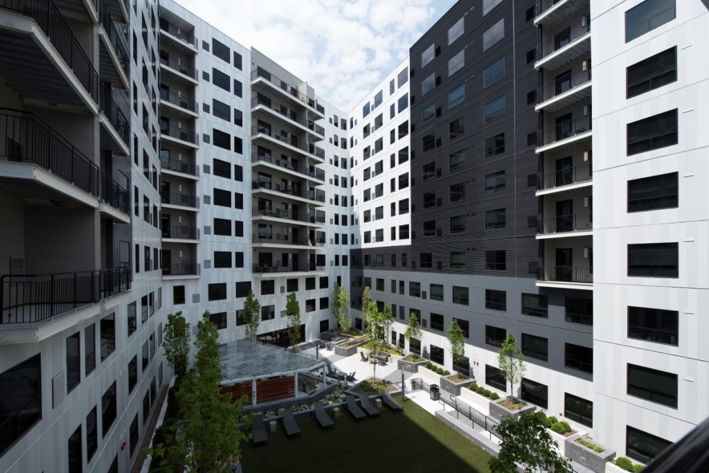 A mix of flush and corrugated metal panels in black, white and grey provides a sophisticated façade to the SkyVue Apartments in Pittsburgh. Photo: hortonphotoinc.com