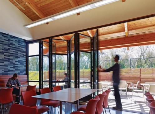 Operable windows throughout the building allow for natural ventilation, and several public areas feature indoor-outdoor space, including this employee dining area.