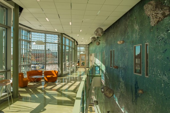 The glazed hallway wall mural includes 308 satellite map images were stitched together into 61 panels and assembled as a wall fabric.