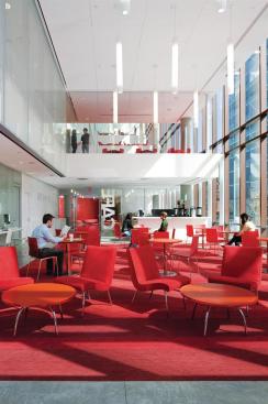 From the caf? in the southeast corner of the ground floor, students can see up through the slipped atria to a more formal dining area, a reading room, and finally into an art gallery on the fourth floor. The architects branded this series of spaces with tones of red and orange, similar to the tones used in the fa?ade. Much of the furniture was custom designed, including the resin tabletops, which were a collaboration with 3form. The caf? has computer workstations tucked against the west wall; a fritted glass wall encloses the faculty dining room on the second floor, which looks down into the caf? space.
