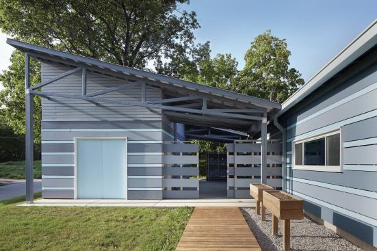 Reconfiguring the typical Heartland Habitat house layout allowed El Dorado to create an outdoor room between the house proper and the detached garage.