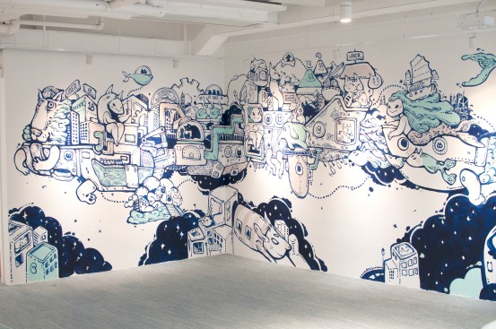 An intricate wall art by local artist Bao Ho envisions a floating city vessel, packed with Hong Kong landmarks, futuristic transports and lucky Feng Shui symbols for the company