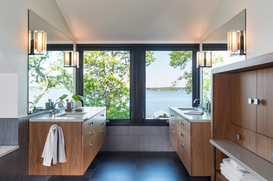 Modern bathroom with custom walnut vanities and beautiful view outside window