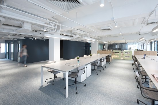 Work clusters occupy the open neighborhoods, each with access to shared supports and collaborative work zones