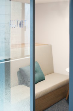 Private phone booths are incorporated into the undulating vessel