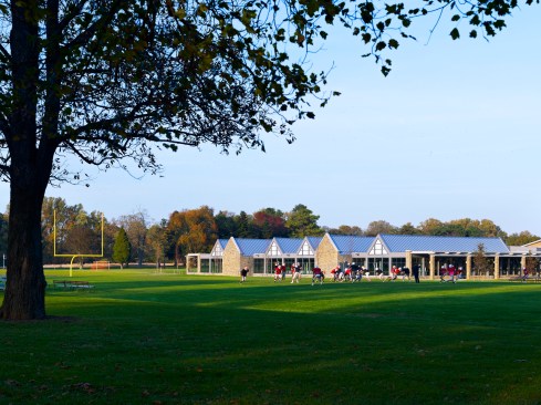 The field house?s bright white TPO and standing seam metal roof is designed to reflect rather than absorb sunlight, minimizing heat island effect.