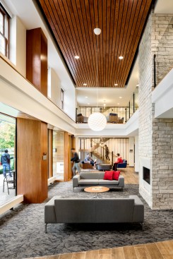 The welcoming and atmospheric two-story entry space at the Martindale Hall is designed by Shepley Bulfinch in earthy tones, inspired by the connection to the Arboretum.  