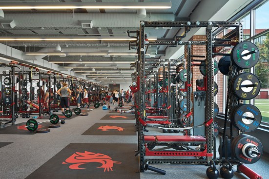 The strength and conditioning weight room opens directly onto Rogers practice field.