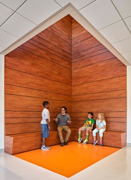 Flex classroom space with skylight utilizes wood and natural materials, drawing on European references.