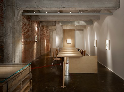 Ghost+Gallery+seats+a+maximum+of+10+surrounding+a+Baltic+Birch+slab+table.++The+west+end+of+the+table+is+the+focal+point+art+for+discussion.+Notice+the+random+seating%2c+the+hors+d%e2%80%99oeuvre+table+made+of+used+wood+pallets%2c+and+the+exposed+exterior+masonry+wall.++The+1911+concrete+slab+is+uneven.++We+celebrate+this+historic+detail+with+custom+made+wood+shims.