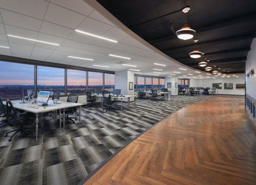 Trustify's eighth-floor panoramic windows flood the modern, affluent space with light and views, at dusk haunting, of Washington, DC and Arlington, VA. The omniscient angle enhances and borders the preexisting base building curve, the dropped ACT ceiling, exposed slab and view into the neighboring cities bordering the unique space.