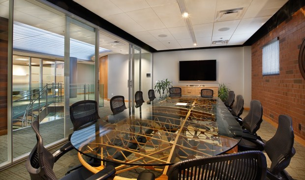 Second floor conference space. Exposed brick nods to the stoic and sturdy composition of the existing main building.
