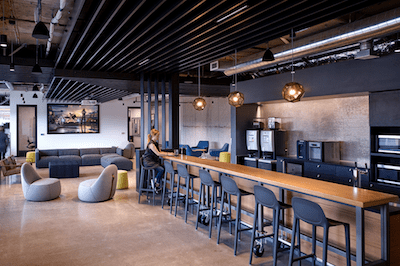 A sleek industrial material palate shapes the pace, evoking the creation of the racing automobile.