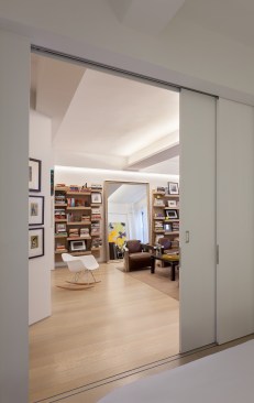 The bedroom is enclosed by large scale sliding panels which double as art walls. The walls may be closed while entertaining guests and opened to completely integrate the bedroom and living room into one open space.