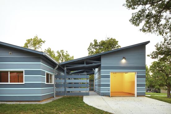 The garage is connected to the house by a set of canted metal roof planes, formed from Firestone Metal Products Una-Clad and Galvalume.