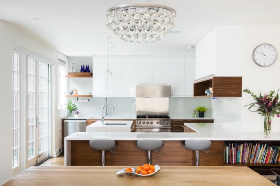 Large kitchen islands allow flow throughout the kitchen and ample seating; large glass doors replace the claustrophobic mudroom to open onto the new bluestone patio