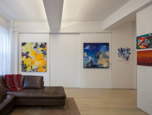 The bedroom is enclosed by large scale sliding panels which double as art walls. The walls may be closed while entertaining guests and opened to completely integrate the bedroom and living room into one open space.