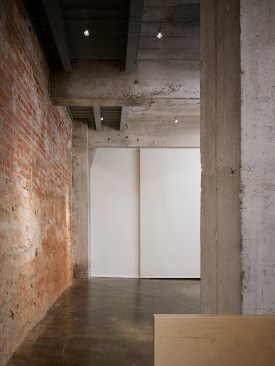 The+art+storage+doors+can+be+closed+and+covered+with+an+opaque+roller+shade.++An+empty+wall+is+the+balance+for+art+of+the+evening.++