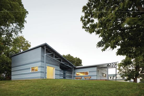 The house and garage are clad in a cement board panel rainscreen.