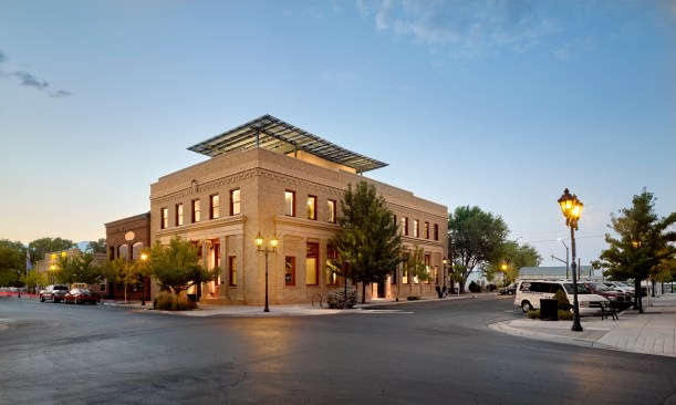 Restored 1916 Neoclassical Farmer's Bank at dusk, with rooftop solar panels