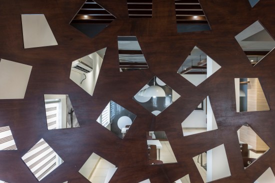 A solid and void cutout partition is used to segregate space and maintain visual connectivity.