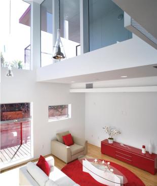 Double-height living rooms allow ample views onto the landscaped park, which is maintained using city funds.