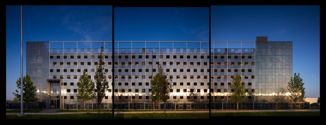 The north elevation illustrating the polycarbonate skin set in a square grid bris soleil.  Corner stairs are articulated as transparent volumes and the main volumes are punctuated with openings to satisfy the 25% open requirement by code. 