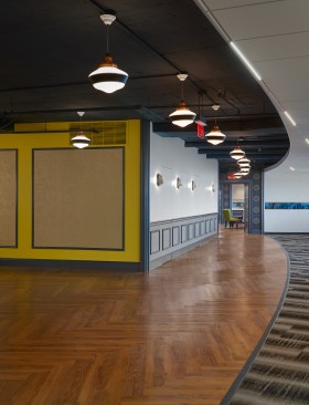 Shaw LVT Herringbone flooring pattern adds warmth to the open office corridor.