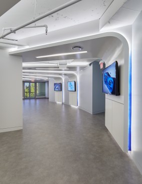 The corridor’s dropped walls are bordered with dashboard inspired cove lighting, highlighting interactive zones for events.