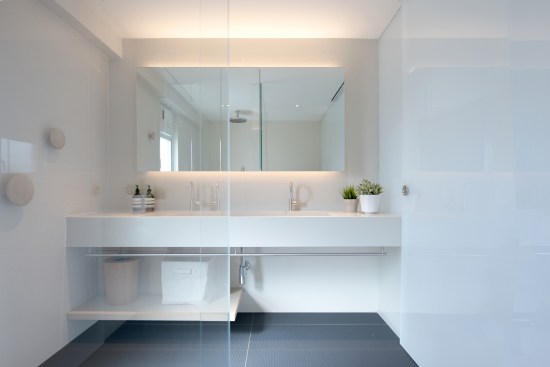 The bathroom celebrates natural materials and translucent partitions, keeping the space minimal and clutter free.
