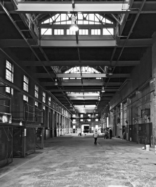 A vast industrial garage will become a Food Hall that opens onto an adjacent city park.