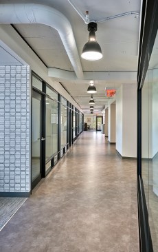 The bronze-framed storefront glass system for the private offices evokes the industrial roots of the automotive industry and expands the breadth of the private and open office spaces. Nods to Ford and Lincoln’s heritage are seen throughout, including the lounge and restroom wall coverings and graphics.
